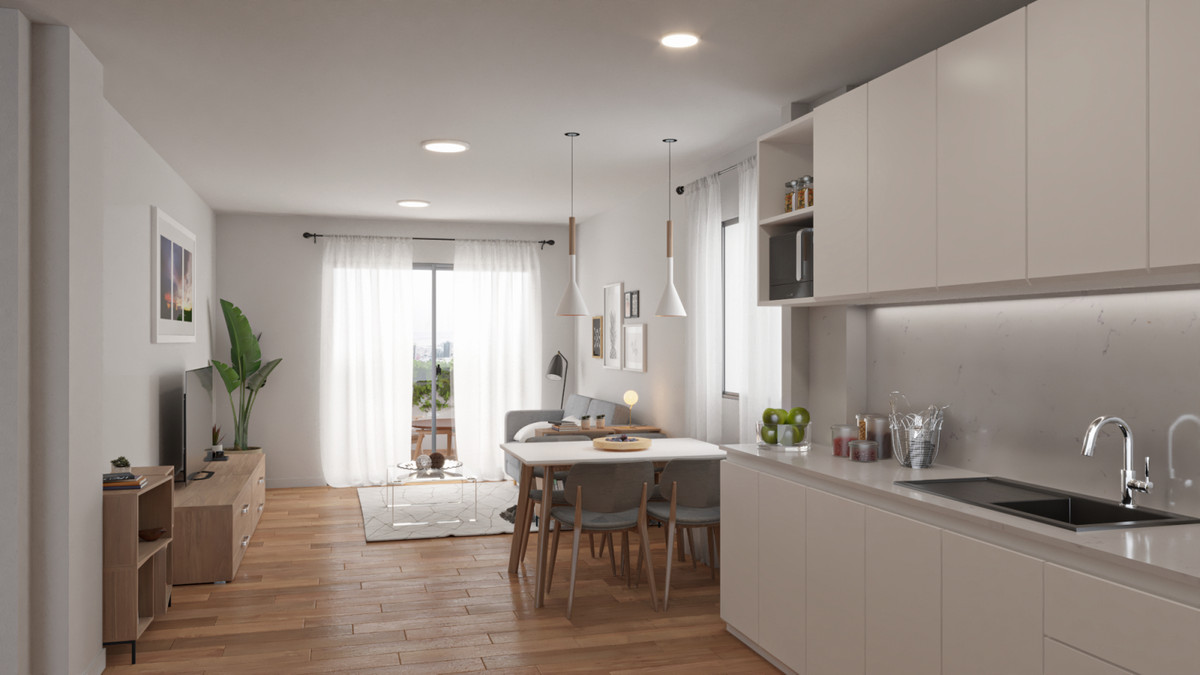 Coral Mijas Residencial – open-plan kitchen, dining area and living room with warm wood floors and white cabinetry