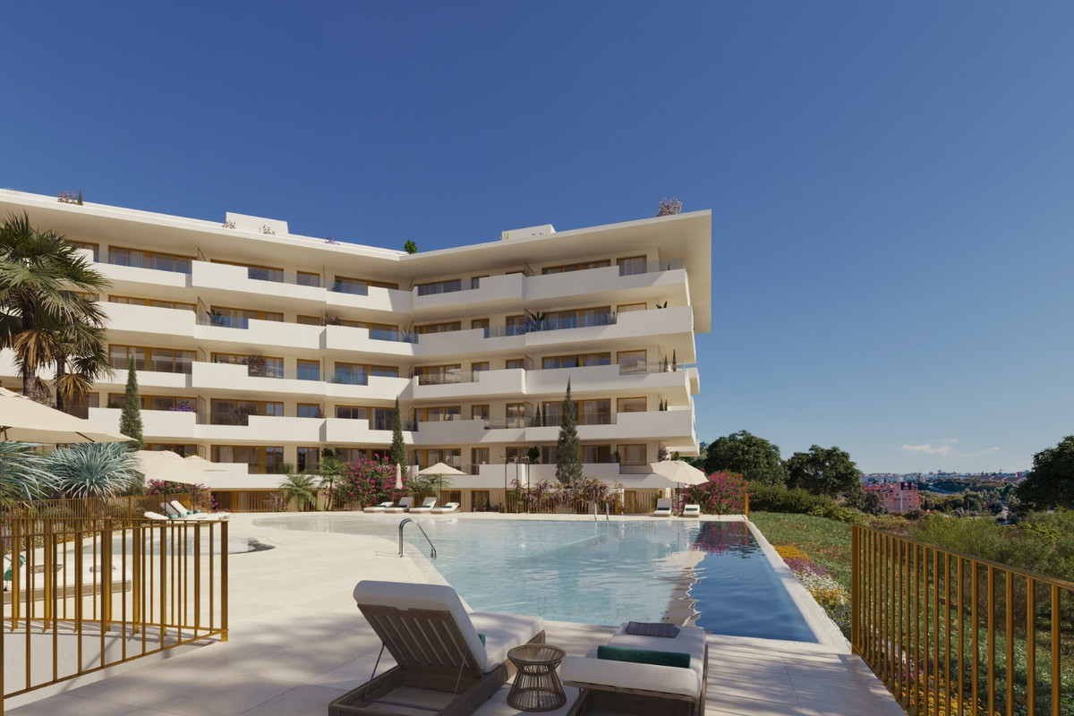 LUMINAL HOMES – Fuengirola - white modern residential complex with outdoor swimming pool, sun loungers and landscaped gardens