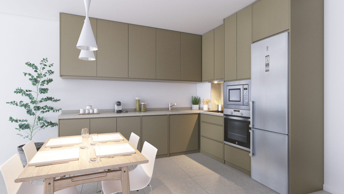 Amphora Beach Fase IV – Manilva - modern open-plan kitchen with olive-green cabinetry, built-in appliances and dining area