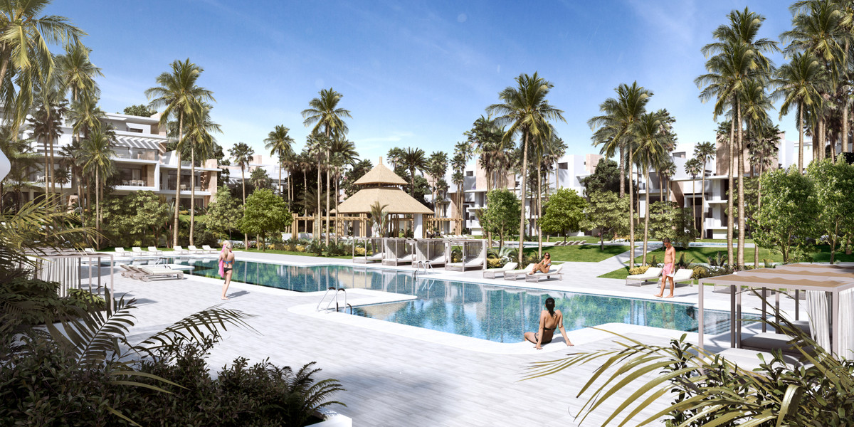 Ayana Estepona – New Golden Mile - luxury outdoor pool surrounded by palm trees and tropical gardens with modern residential buildings