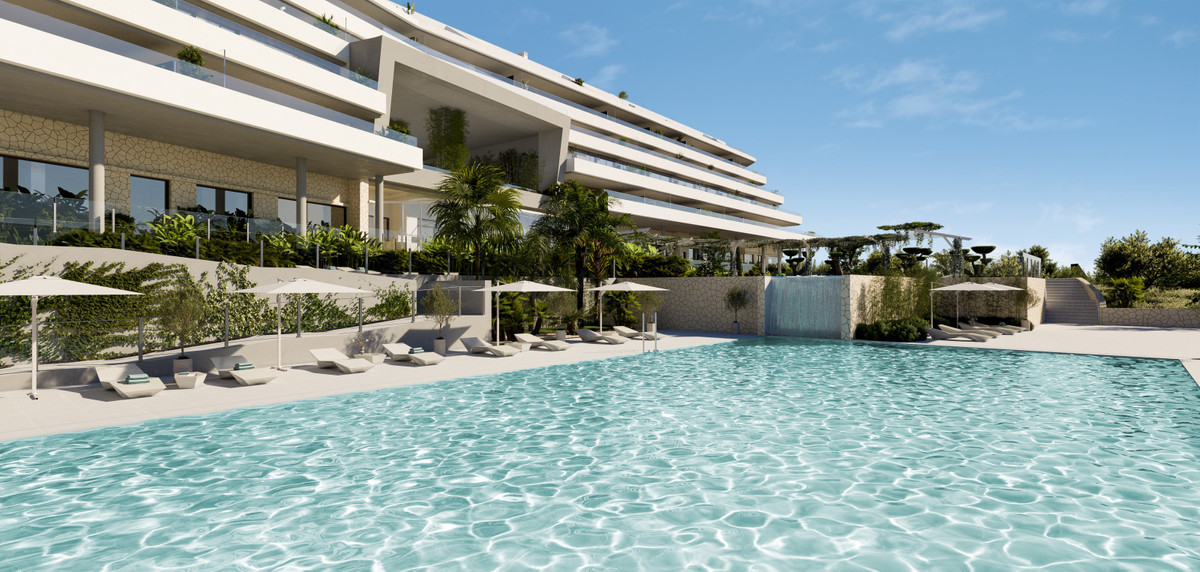 CORE HIGUERON Fase II – Fuengirola - luxury infinity pool with sun loungers and tropical landscaping fronting a modern white stepped apartment complex