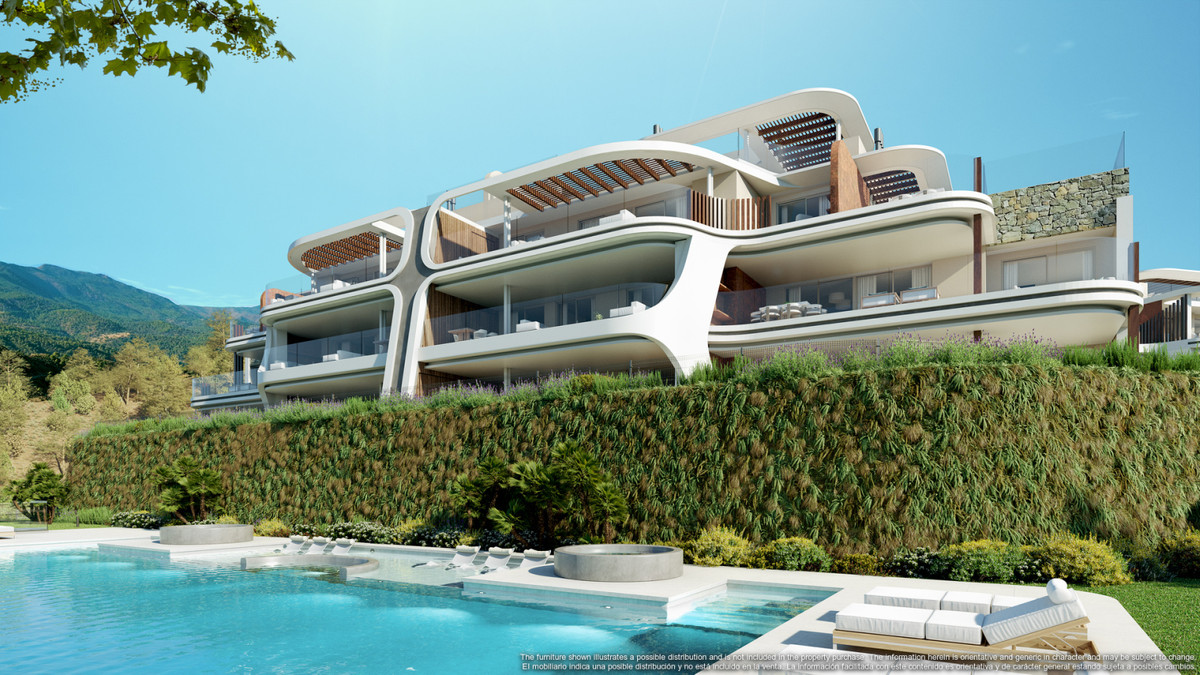 Enebros Fase 1 – Benahavís - curved white facade with pool, terraces, and lush hedge landscaping against mountain backdrop