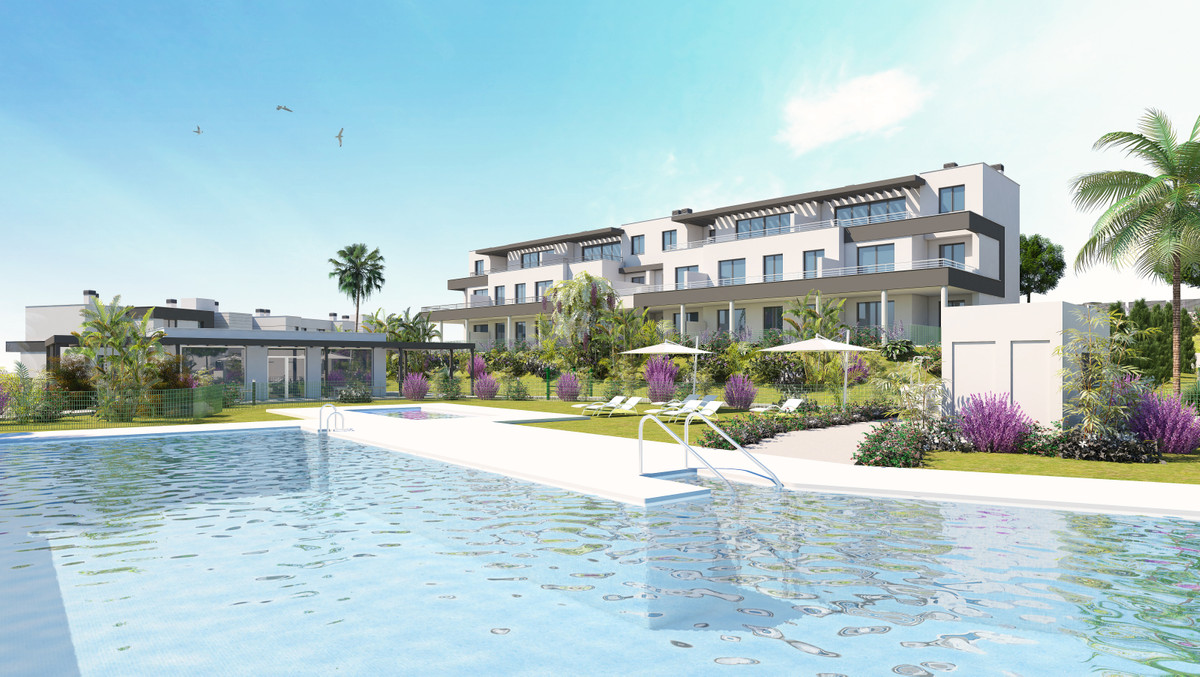 Habitat Valle Romano – Estepona - modern residential complex with communal pool, lush gardens and palm trees under a blue sky