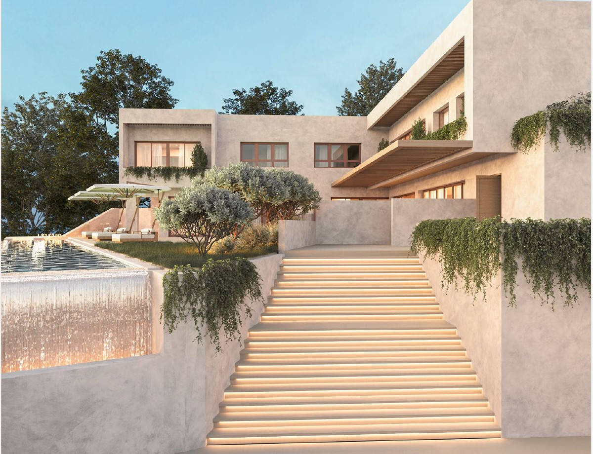 HL SG122 – Alhaurín el Grande - illuminated exterior staircase leading to a terraced luxury villa with infinity pool and landscaped gardens