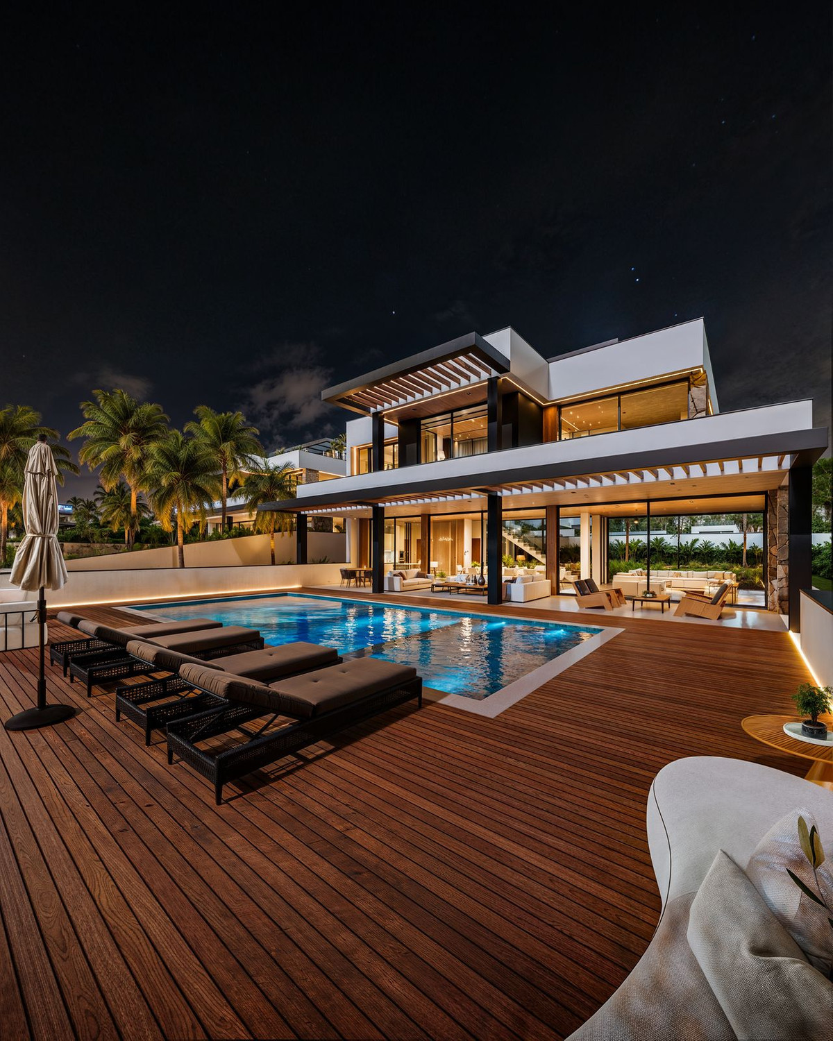 Manzanilla 12 – New Golden Mile - illuminated outdoor pool deck with sun loungers and modern two-storey villa at night