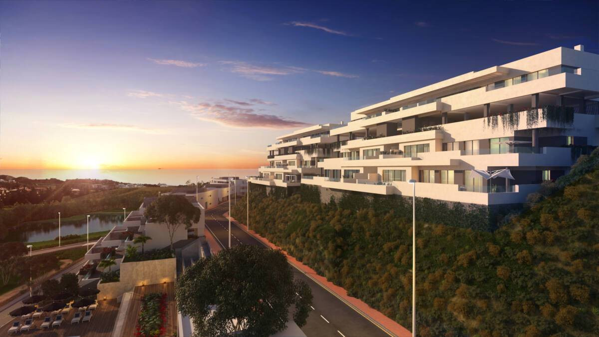 Navigolf Suites – La Cala de Mijas - modern white terraced apartment complex on a hillside at sunset with sea views