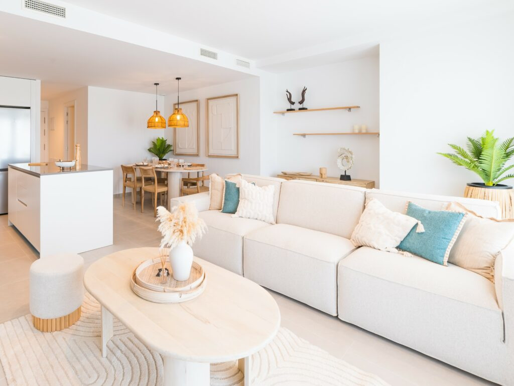 OCEANA GARDENS II – Cancelada - bright open-plan living and dining area with cream sofa, rattan pendant lights and coastal décor