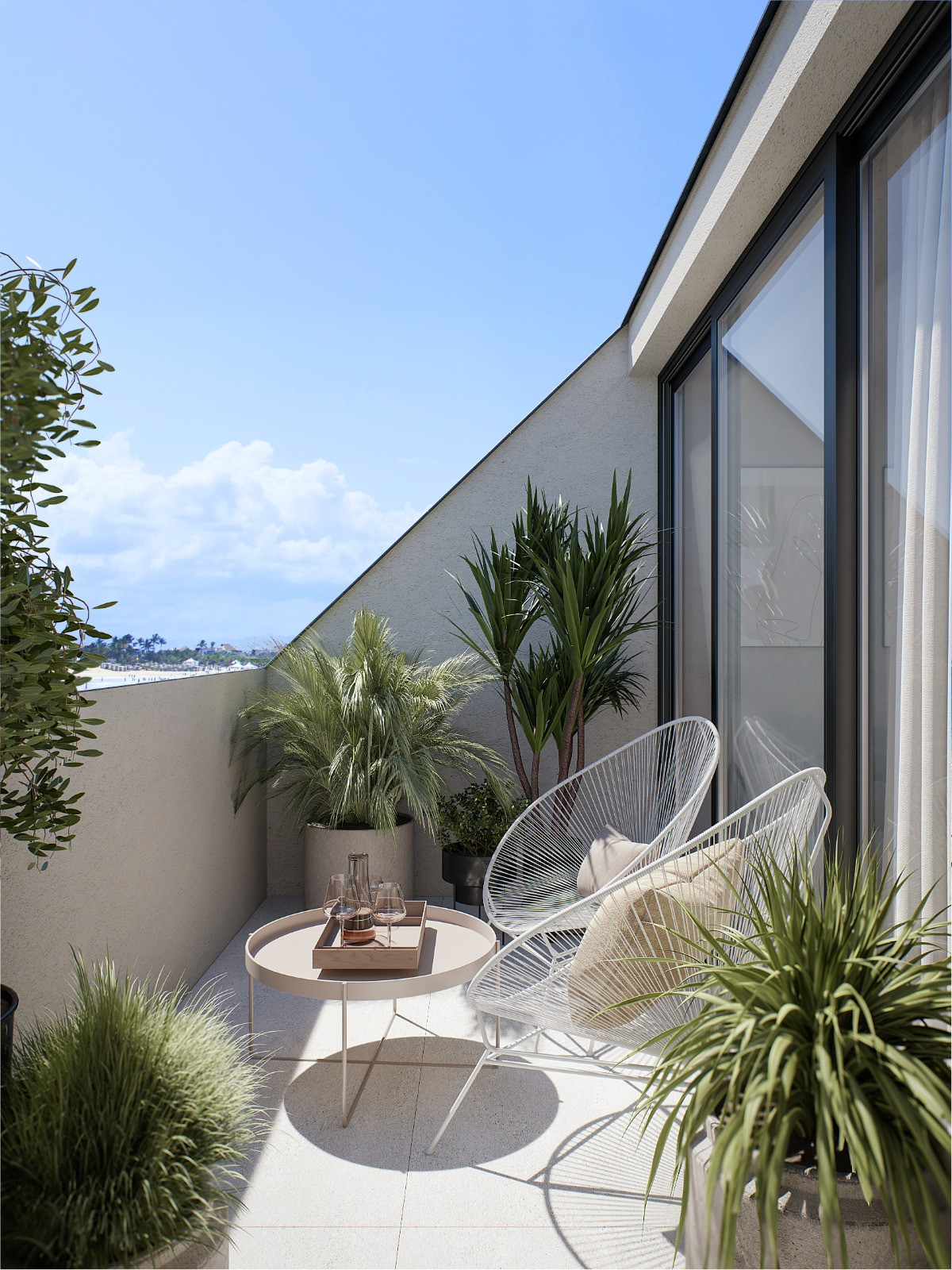 Pelit Maritimo – Fuengirola - sunny terrace with white wire chairs, round table and tropical potted plants overlooking the coast