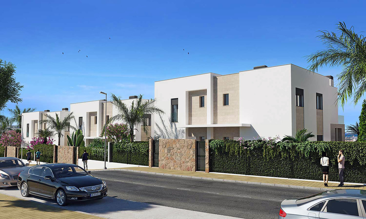 Residencial Cala de Mijas – Mijas - modern white two-storey townhouses with stone wall perimeter hedge and palm trees along a sunny street