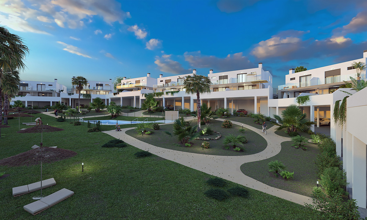 Residencial Cala de Mijas – Mijas - landscaped communal gardens with curved pathways, palm trees, pool and white modern townhouses at dusk