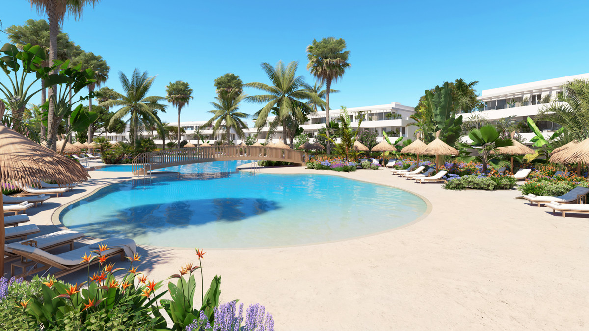 Serenity Frontline Golf Homes and Beach Club – La Alcaidesa - lagoon-style outdoor pool surrounded by palm trees, sun loungers and tropical gardens