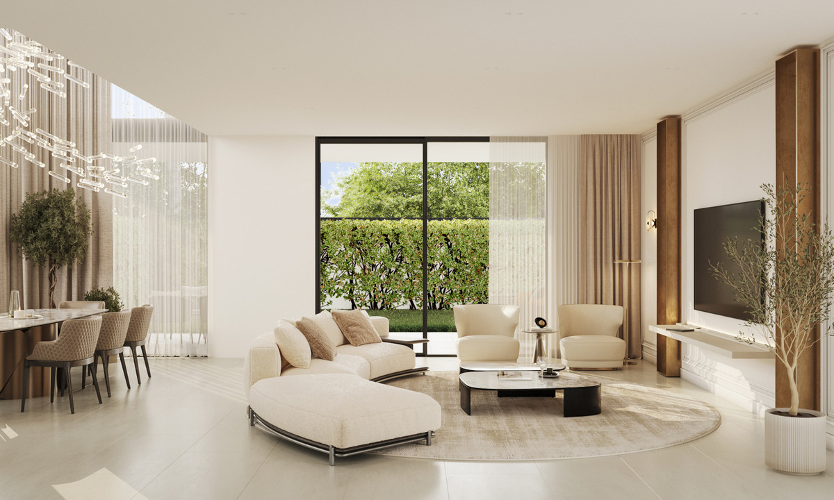 Sirocco Villas – Marbella - bright open-plan living room with cream sectional sofa, round rug, and floor-to-ceiling garden views