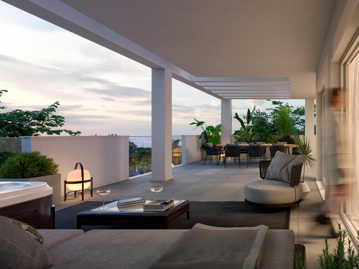 Stella 8 – Benalmadena Costa - luxury terrace with outdoor lounge, jacuzzi, dining area and sea views at dusk