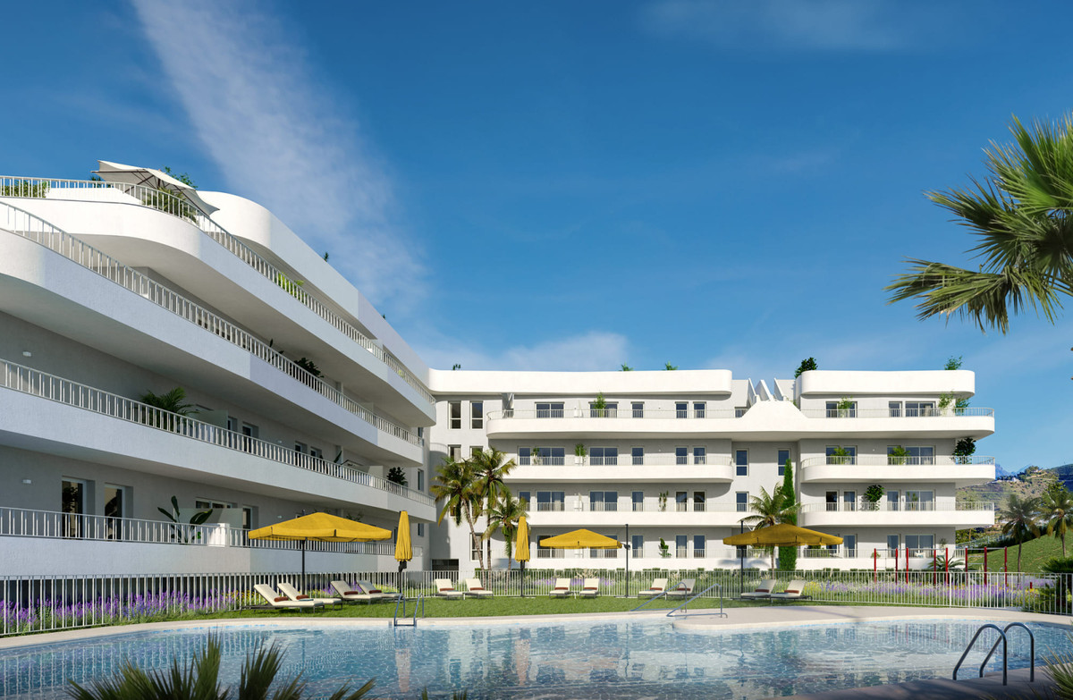 Sunset Views – Fuengirola - modern white residential complex with communal pool, sun loungers and yellow parasols
