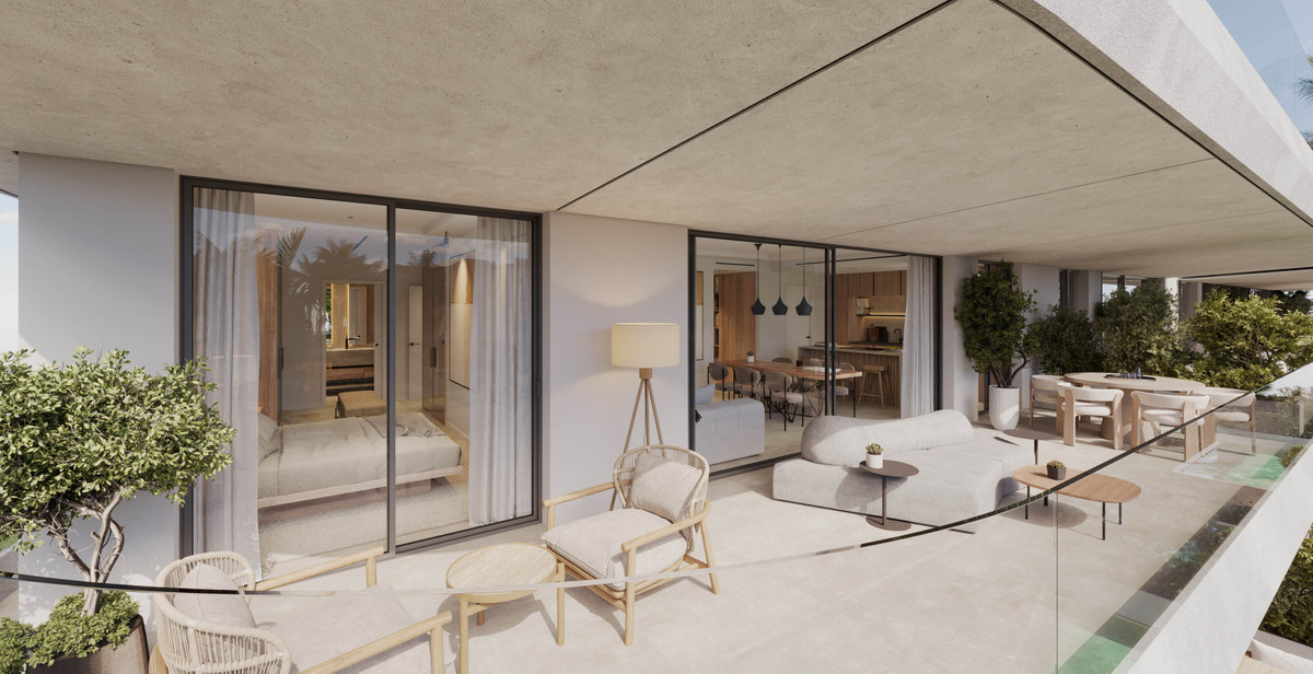 The Palms at Estepona – Estepona - spacious terrace with outdoor seating, glass balustrade, and floor-to-ceiling sliding doors to living area and bedroom