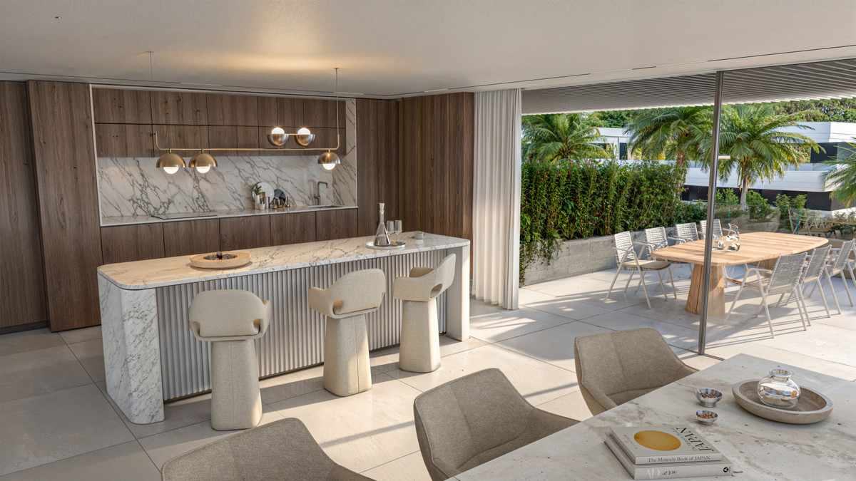 The Privilege – Estepona - open-plan kitchen and dining area with marble island, fluted panel detailing, and terrace views