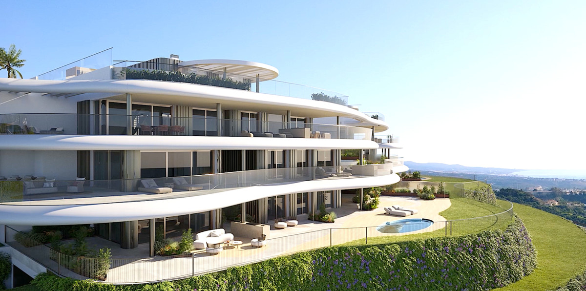 The Sky Marbella Apartments – Benahavís - curved white exterior facade with wraparound terraces, pool and panoramic hillside views