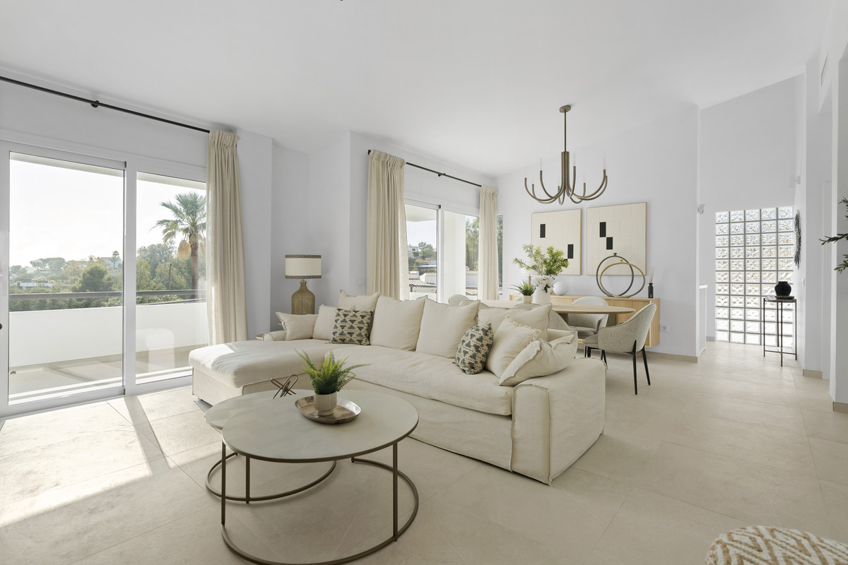 Urbanización Olimpo – Mijas - bright open-plan living room with cream sectional sofa, marble coffee table, and balcony views