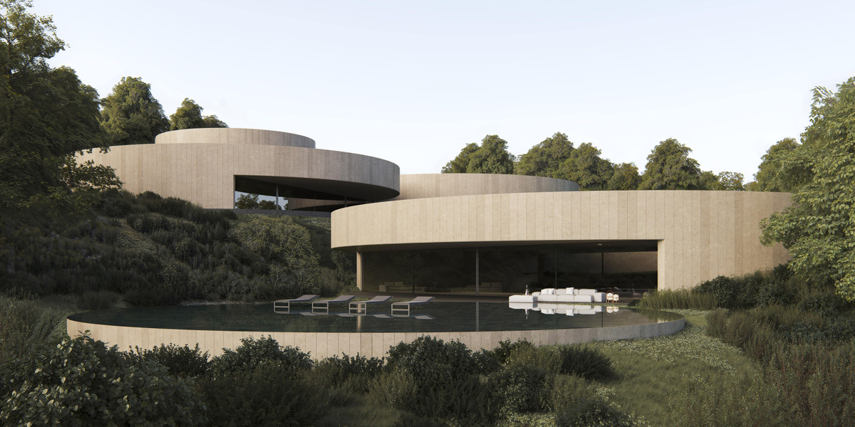 Villa NOON – San Roque - curved travertine exterior facade with circular infinity pool, sun loungers, and lush hillside landscaping