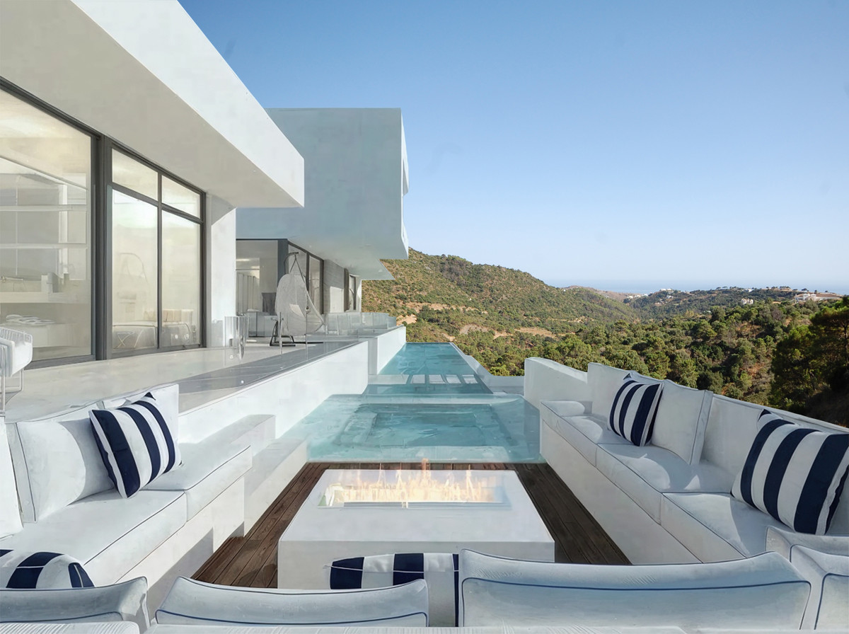 ZOE LUXE – Benahavís - luxury terrace with infinity pool, fire pit, white lounge seating and panoramic mountain views