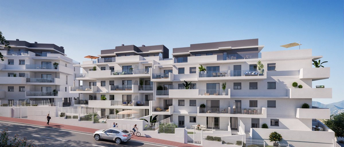 Alonia – Manilva - white modern apartment complex exterior with terraces, balconies and mountain backdrop in Manilva, Málaga