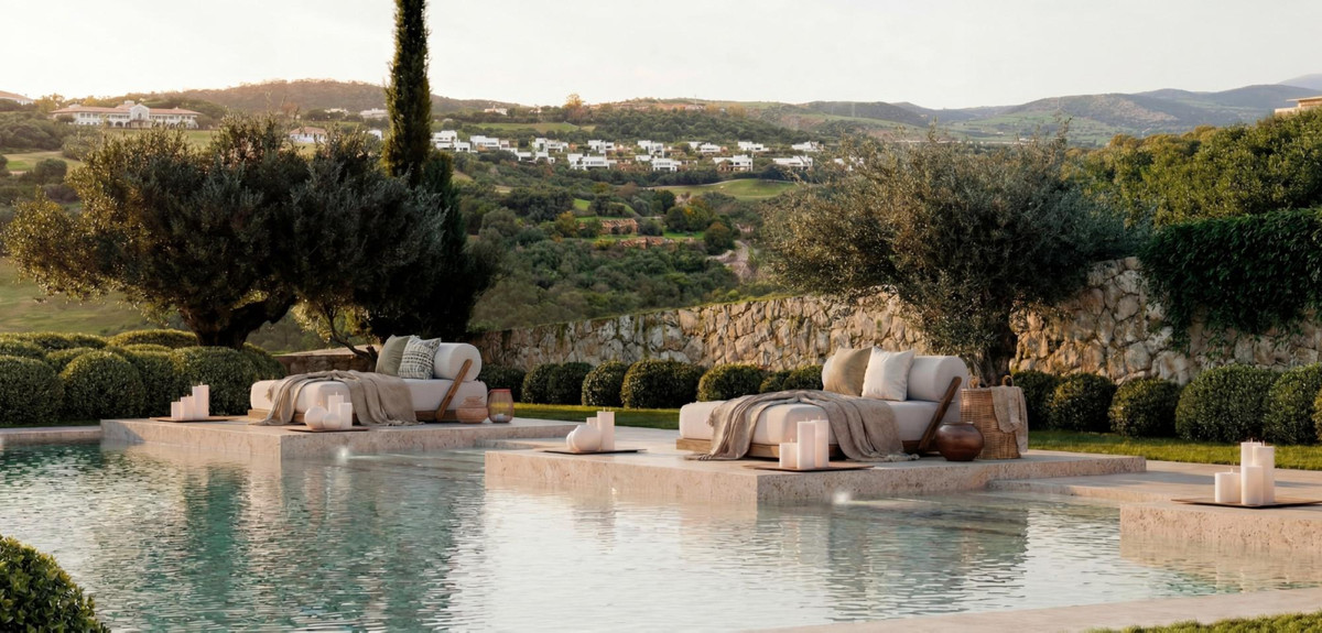 Amenábar Cortesín – Casares - luxury outdoor pool terrace with lounge seating, candles, and panoramic hillside views