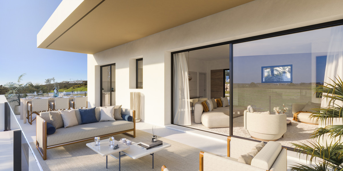 Attire Estepona – Estepona - sunny terrace with elegant outdoor sofas and floor-to-ceiling sliding glass doors opening to a bright interior living area