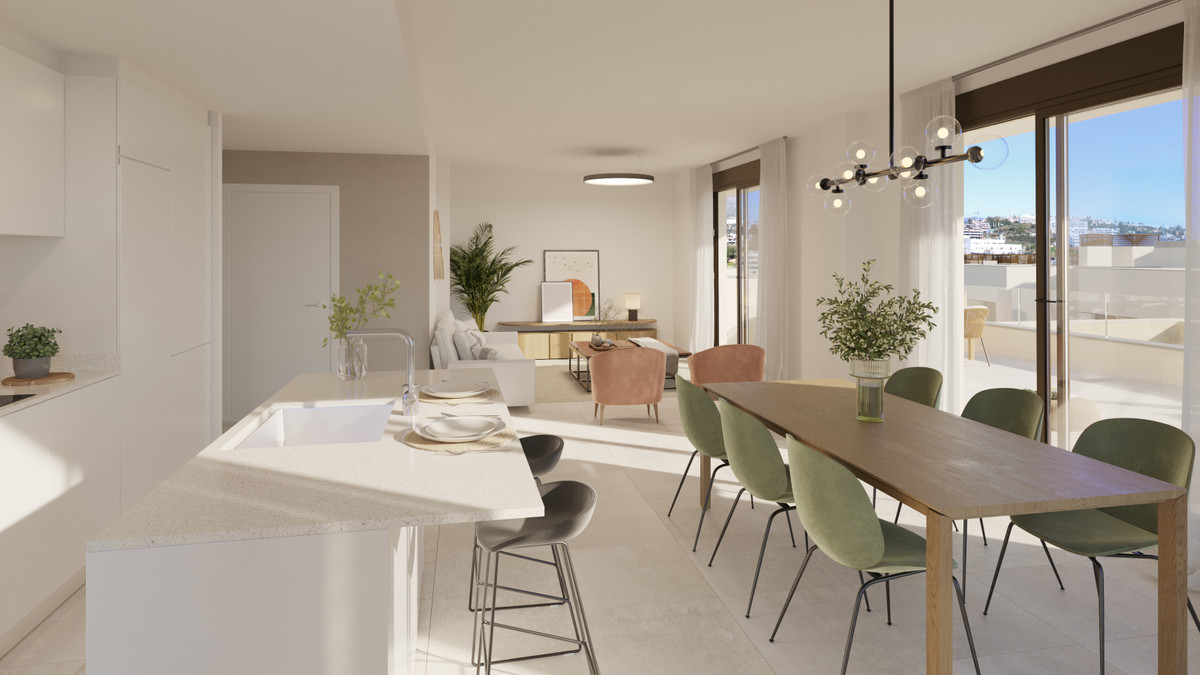 Bayside Homes – Estepona - open-plan kitchen, dining area with green chairs, and living room with terrace access and sunny views