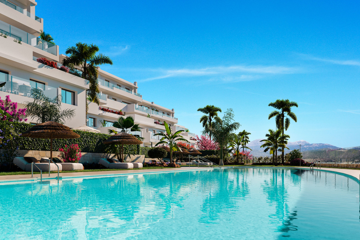 Las Terrazas de Cortesin Bon Air – Casares - luxury outdoor pool with palm trees, sun loungers and white apartment facade against mountain backdrop