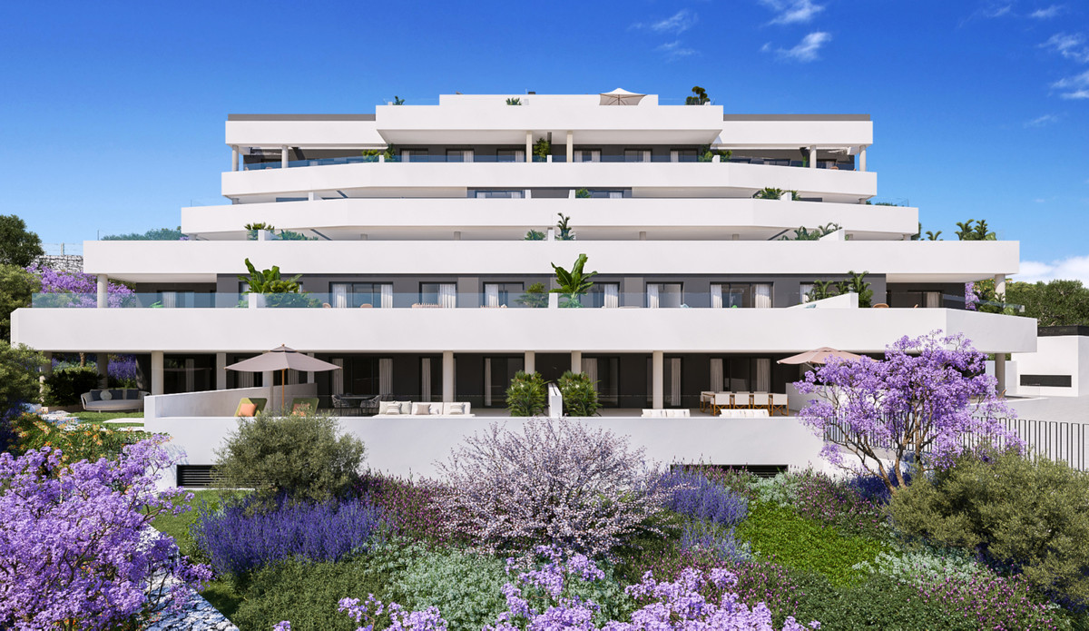 Medblue IV – Altos de los Monteros - modern white multi-storey residential facade with terraces and lush purple flowering gardens
