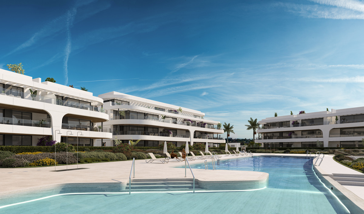 Naya Residences – Atalaya - luxury white apartment complex with communal pool, sun loungers and landscaped gardens