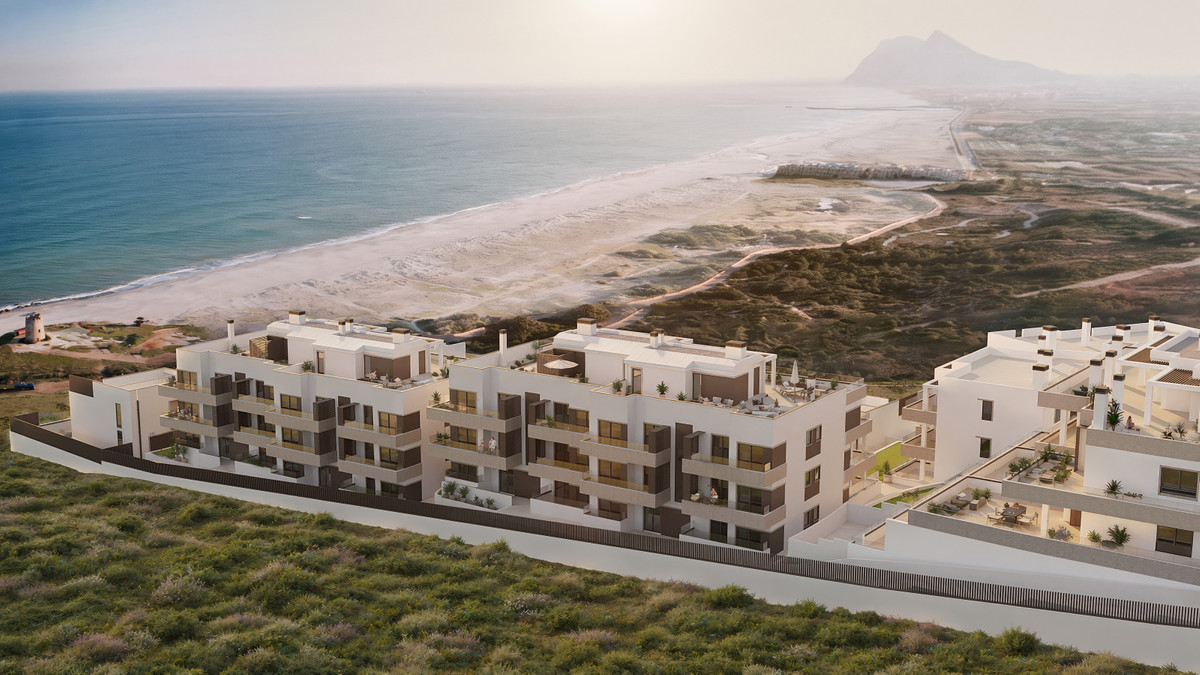 Paraiso Beach – Townhouses – La Línea - aerial view of modern white residential complex overlooking sandy beach and Mediterranean Sea