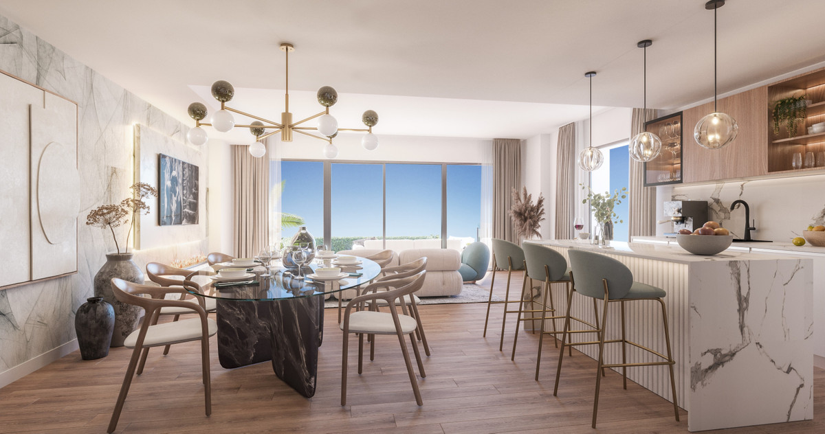 Soleia Living – El Chaparral - open-plan dining and kitchen area with marble island, glass dining table and floor-to-ceiling sea views
