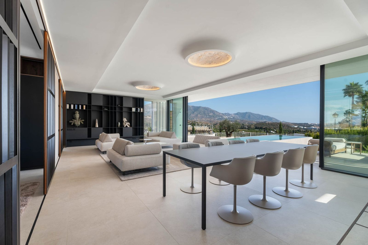 Tree Villas – La Cala Golf - open-plan dining and living area with floor-to-ceiling glass walls, pool and mountain views