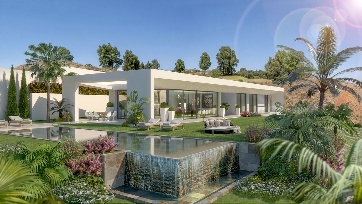 Villa Celestia – La Cala Golf - modern white villa exterior with infinity pool, waterfall feature, lush gardens and palm trees