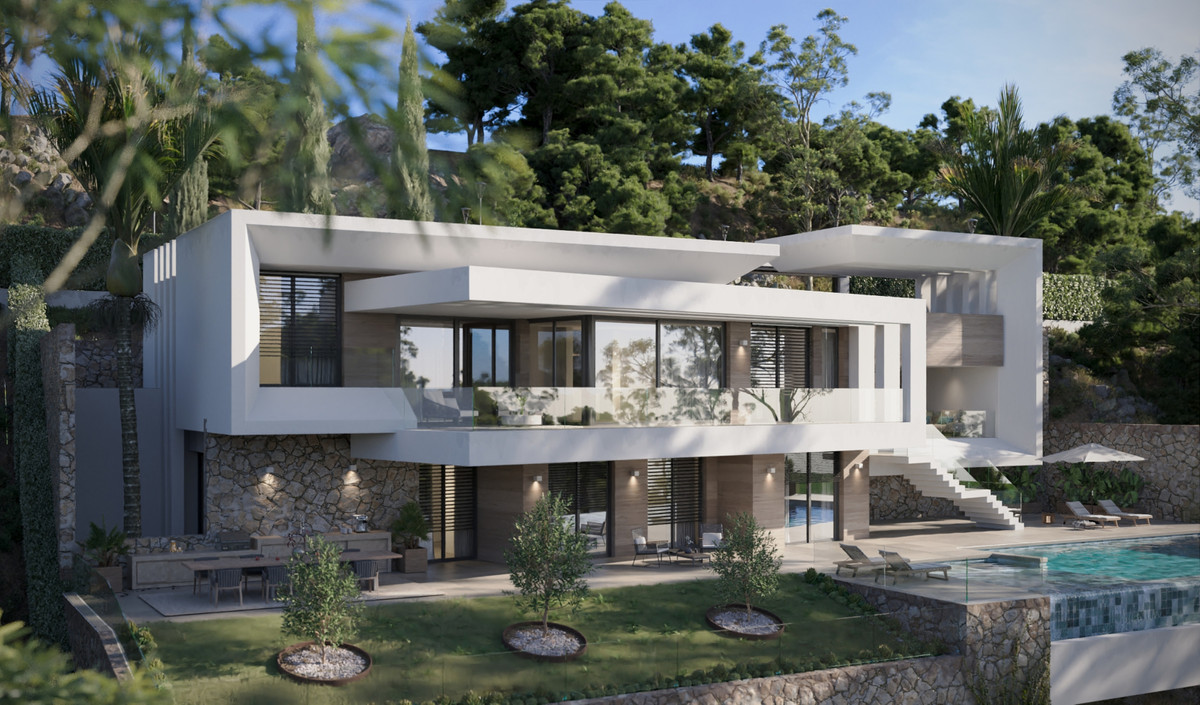 Villa Evania – Benahavís - modern white villa exterior with stone base, landscaped garden, and outdoor pool set against wooded hillside