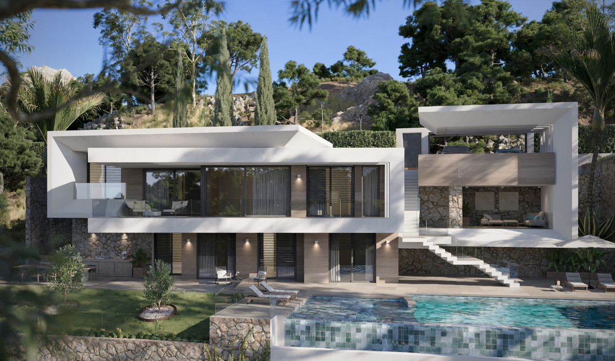VILLA EVANIA Los Flamingos – Benahavís - modern white exterior with infinity pool, terraces and stone accents set into wooded hillside