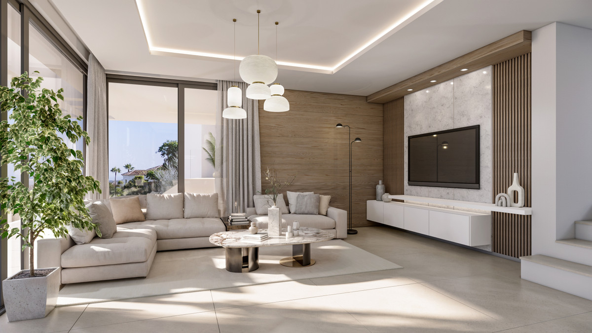 VILLA EVANIA Selwo – Estepona - bright open-plan living room with marble coffee table, sectional sofa, wood accent wall and large TV unit