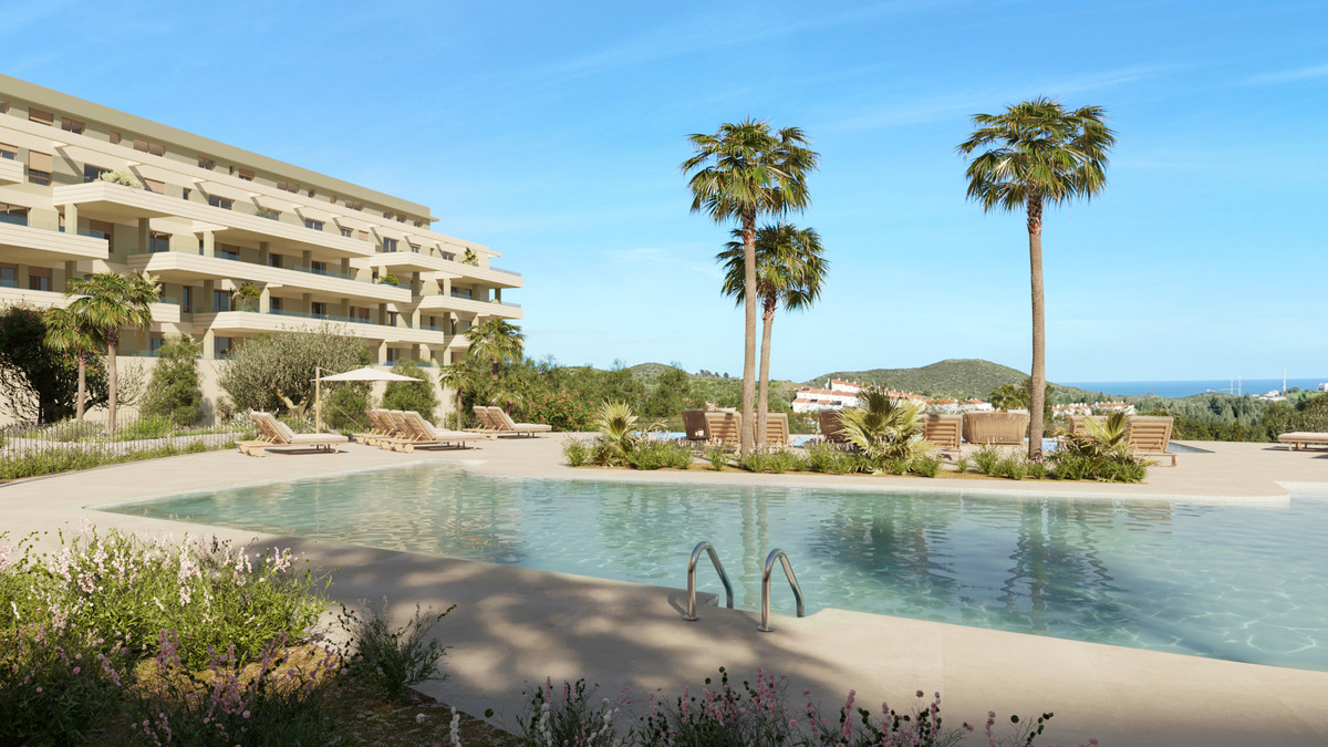 Greenity – Mijas - outdoor communal pool with sun loungers, palm trees and sea views beside the residential building