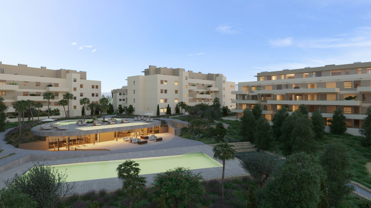 Greenity – Mijas - luxury residential complex with communal pool, landscaped gardens, and beige apartment blocks at dusk