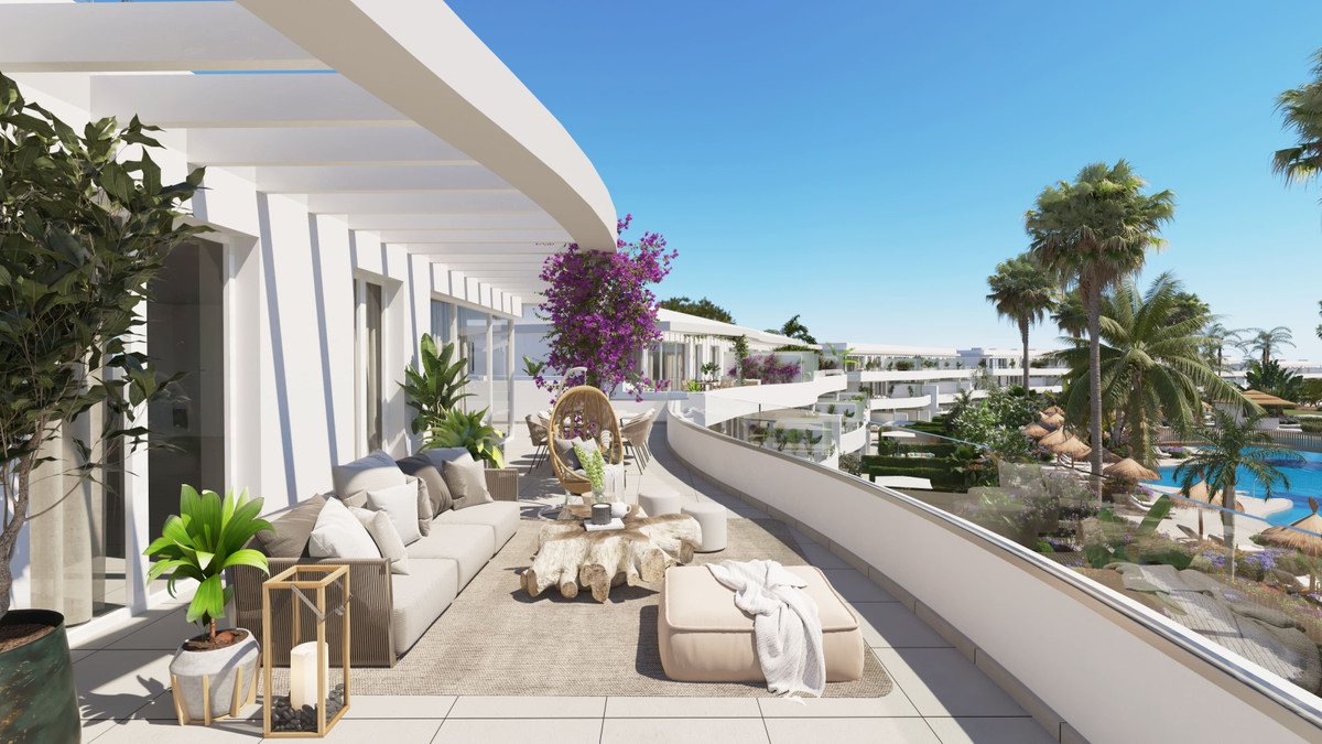 Serenity Frontline Golf Homes and Beach Club – PHASE IV – La Alcaidesa - sun-drenched terrace with lounge seating, tropical plants, and pool views