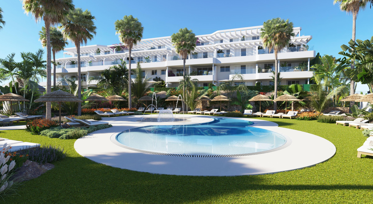 Royal Palms Mijas – FASE IV-4 – La Cala de Mijas - luxury outdoor pool with fountain, sun loungers, tropical gardens and white residential facade