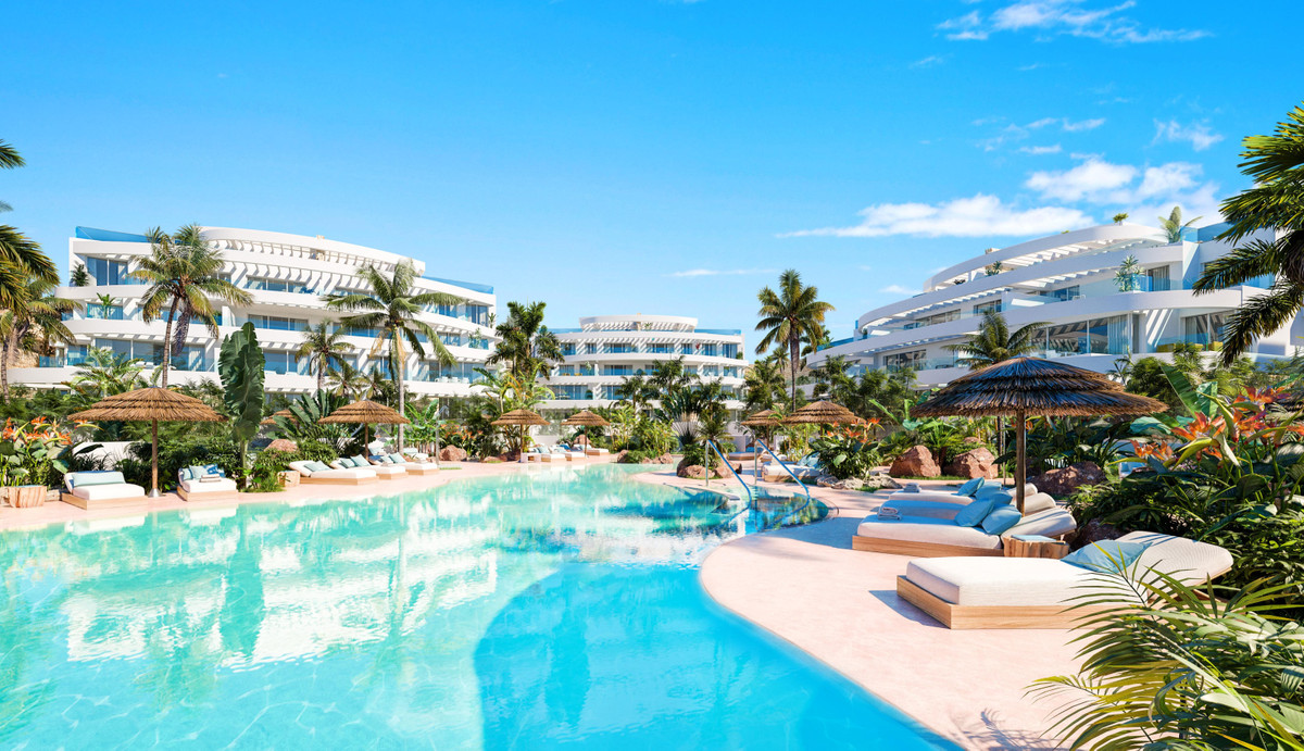 Royal Palms Mijas – FASE IV-1 – La Cala de Mijas - lagoon-style pool with sun loungers, thatched umbrellas and tropical gardens