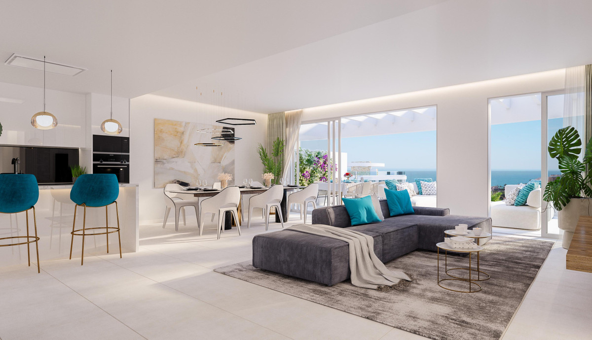 Royal Palms Mijas – FASE IV-2 – La Cala de Mijas - open-plan living room with grey sectional sofa, teal cushions, and panoramic sea views