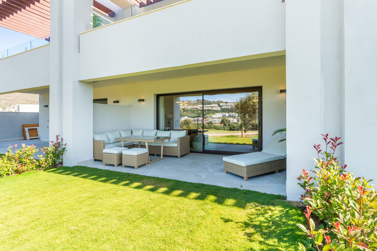 The Meadows – FASE 1 – La Cala Golf - covered terrace with rattan seating, sun lounger, and manicured garden with hillside views