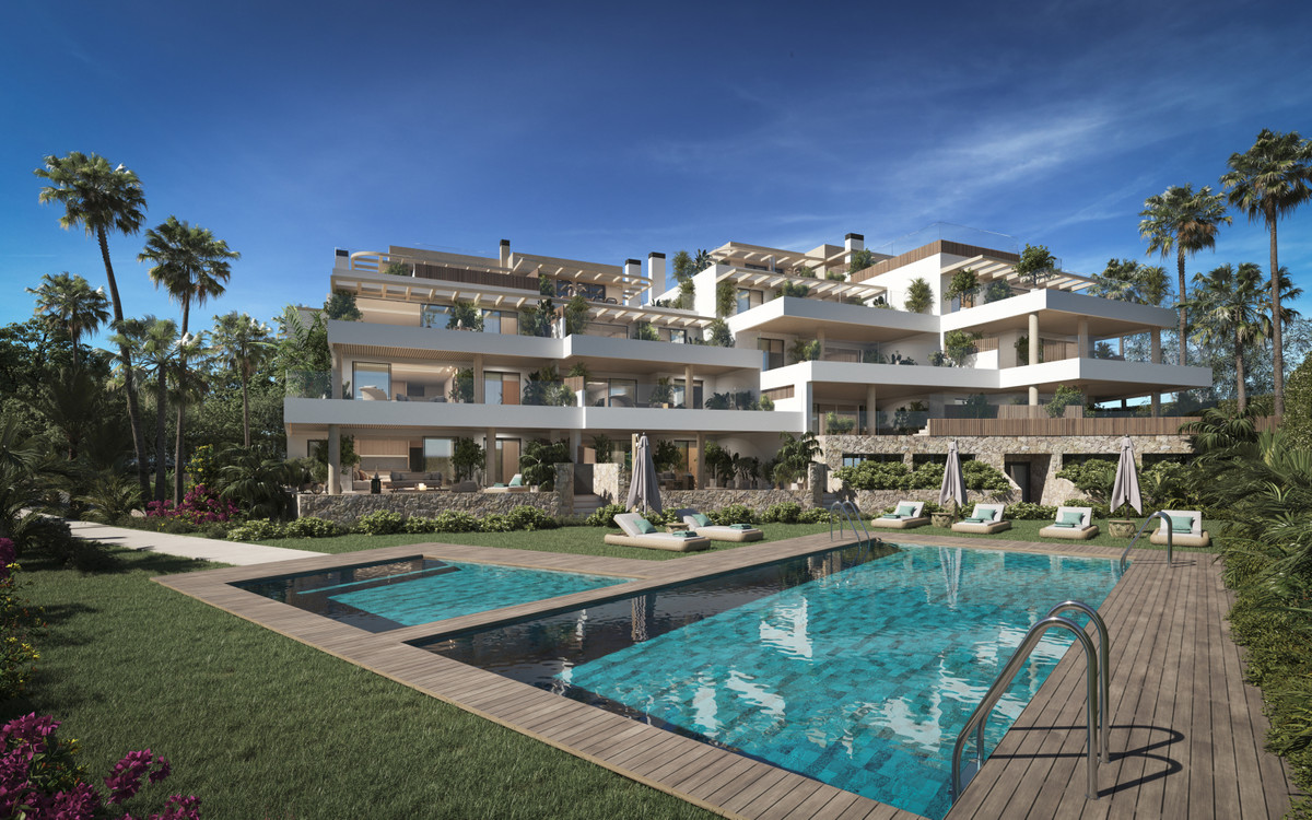 Aruna – Marbella - luxury new-build apartment complex with communal pool, wooden decking, and tropical gardens