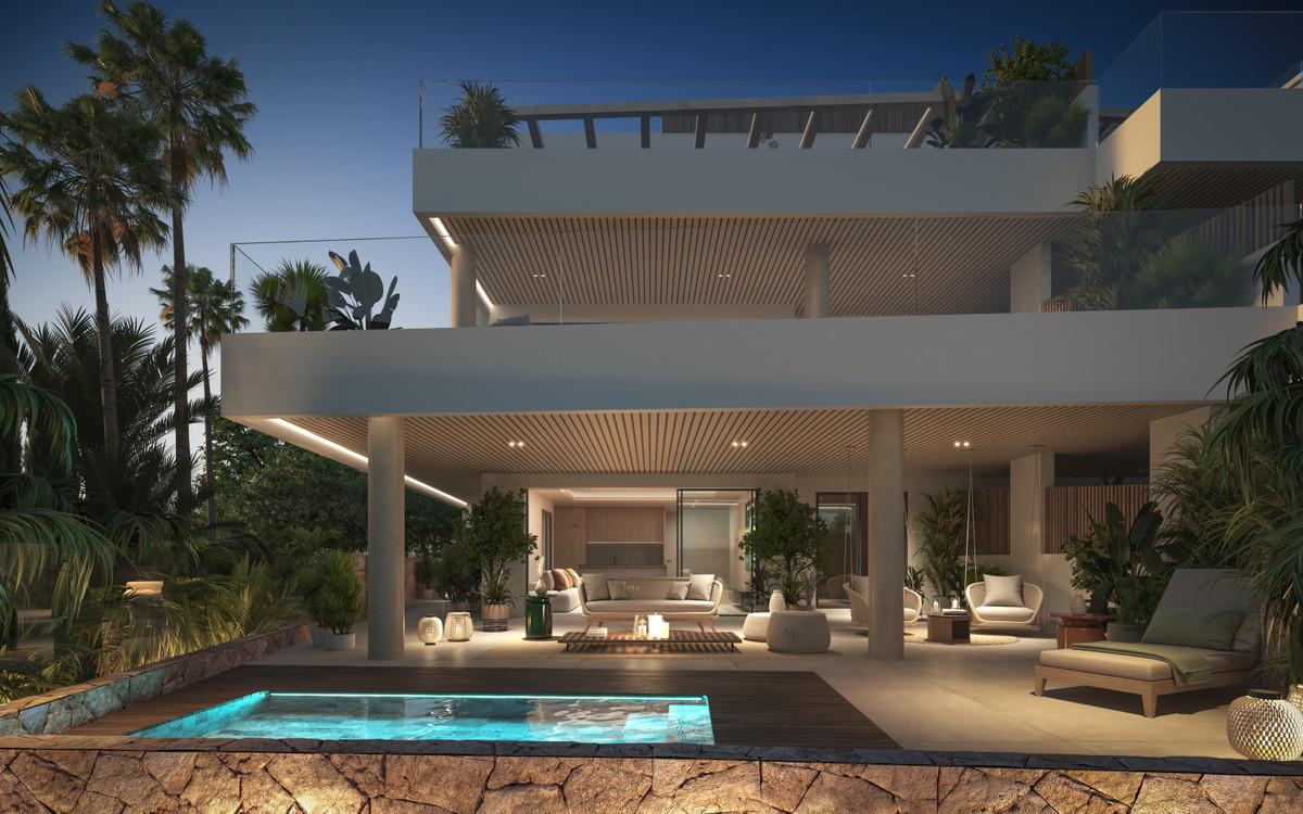 Aruna – Marbella - luxury exterior with illuminated pool, covered terrace, and multi-level facade at dusk
