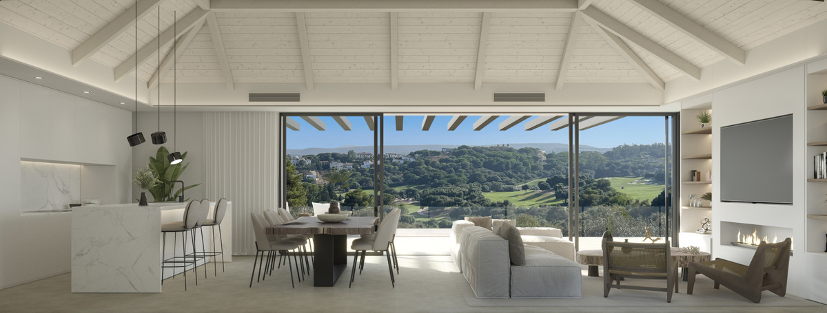 Villa ALHAMA de La Reserva – San Roque - open-plan living, dining and kitchen with vaulted white ceiling and panoramic golf and hillside views