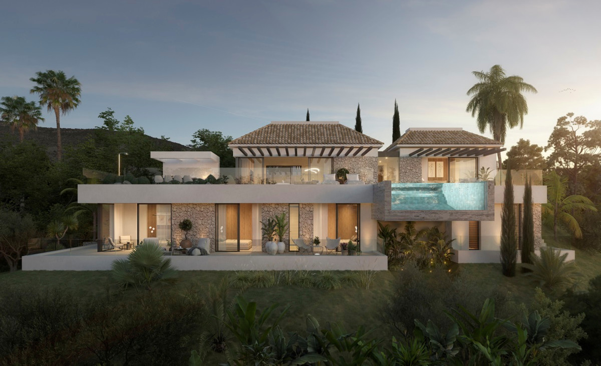 Villa ALHAMA de La Reserva – San Roque - luxury exterior facade with elevated pool, stone cladding and tropical gardens at dusk