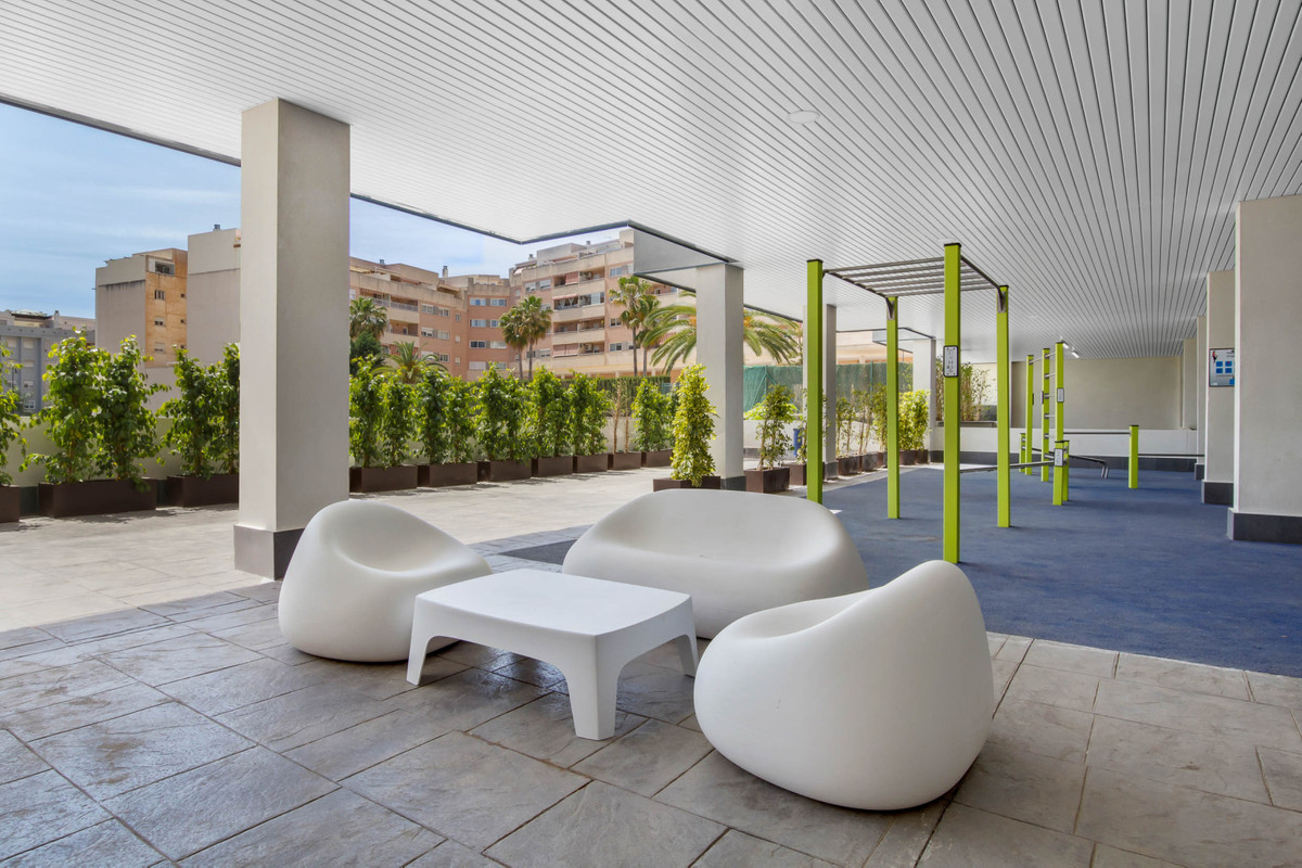 Suite Mijas I – Mijas - covered rooftop terrace with white pod seating, green planters and lime-green pergola pillars